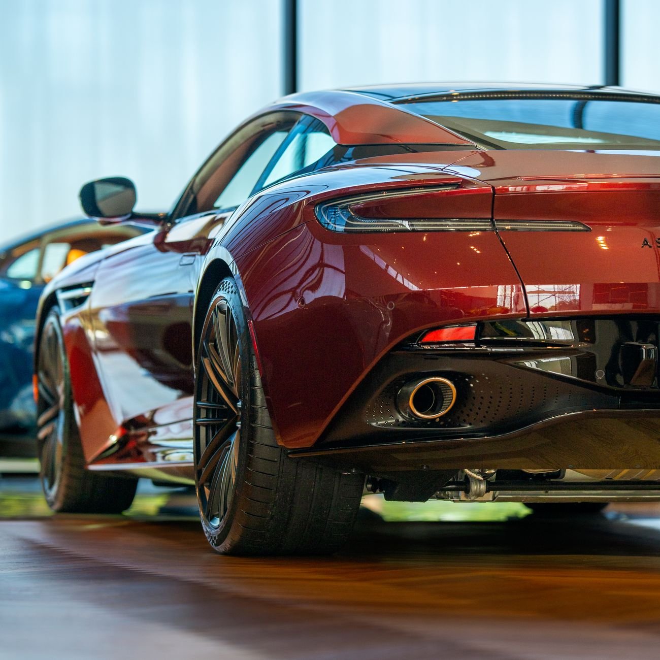 Elegant red sports car showcased in a modern showroom.